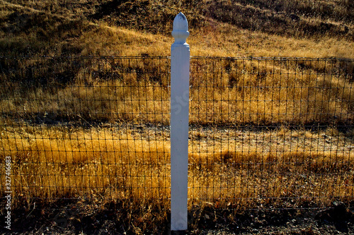 Wire fence with post and acorn finial