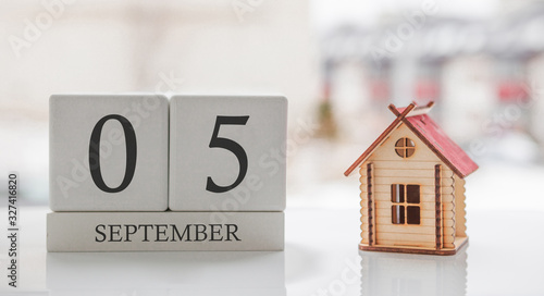 September calendar and toy home. Day 5 of month. Card message for print or remember