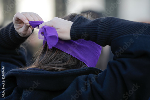 Woman blindfolds herself during a feminist flashmob in downtown Bucharest. photo