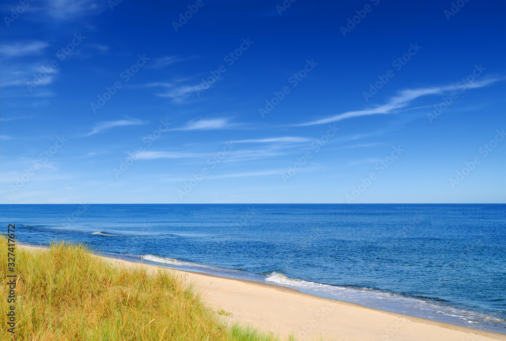 Seascape, empty sandy beach and blue sea