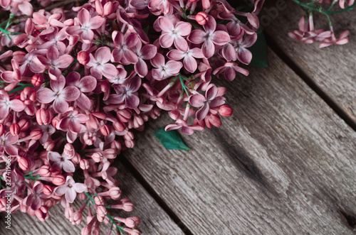 Closeup Purple lilac flowers on a old wooden surface. Spring holidays background.