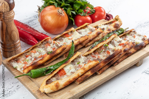 Turkish pide with flaked meat, kusbasi Pide. Traditional Turkish cuisine. Turkish pizza Pita with meat. Turkish name; Recai (Kusbasili Kasarli Pide) photo