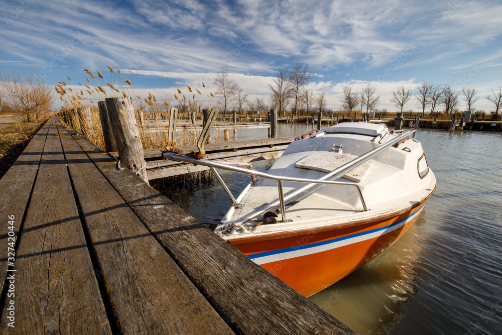 Boat at a Pier of Lake Neusiedl in Austria with blue sky
