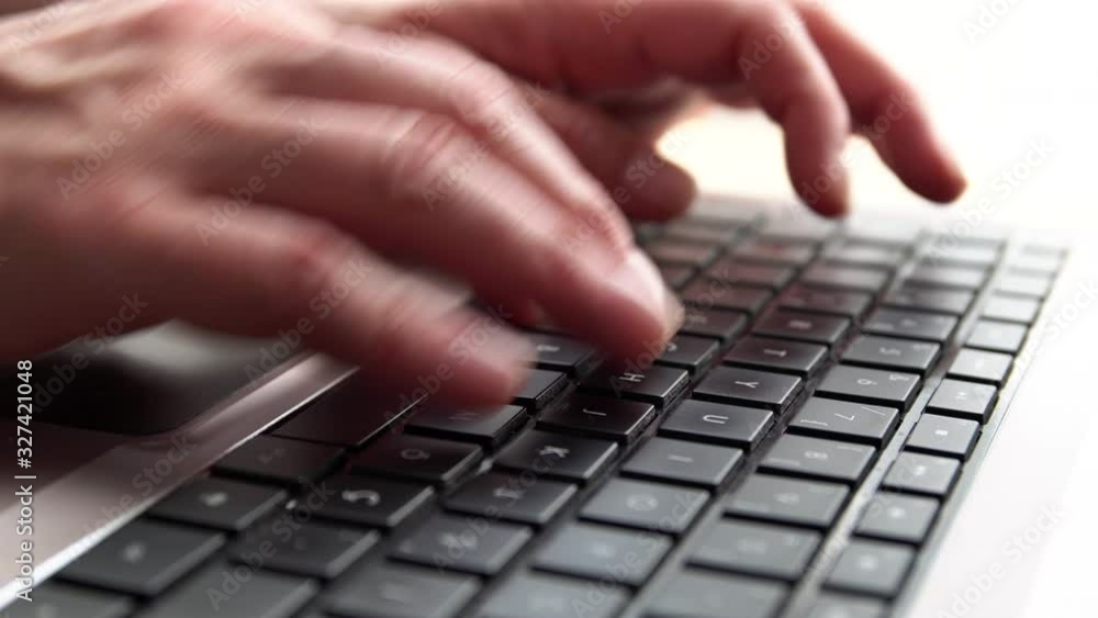 Hands writing on keyboard with black buttons Hands writing on keyboard with black buttons