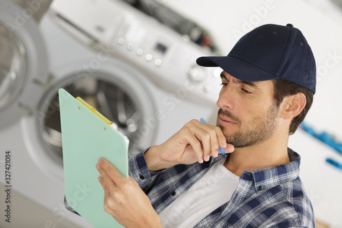 man technician repairing a washing machine
