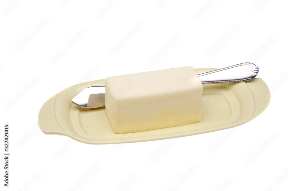 A butter dish with butter knife isolated on white. A butter dish with butter knife isolated on white.