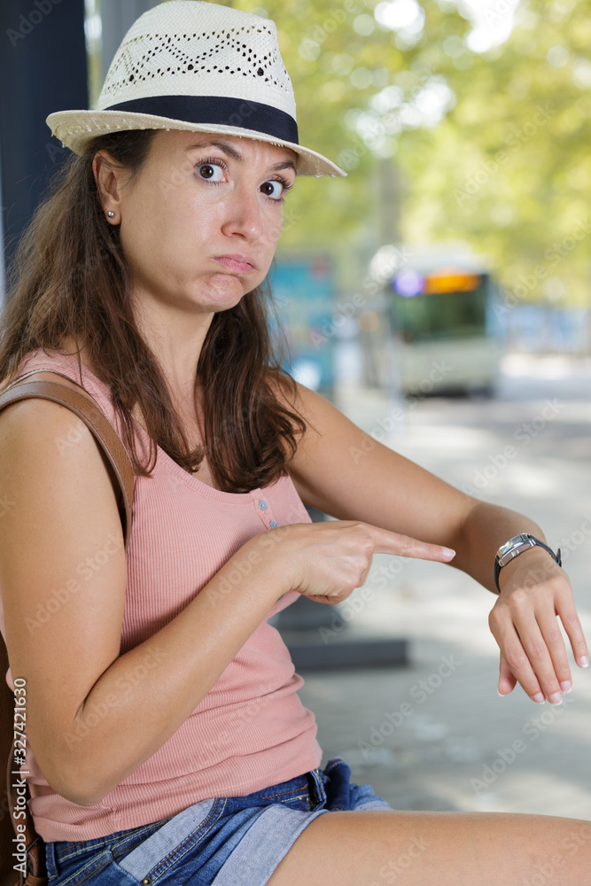 frustrated woman waiting for bus late for airport
