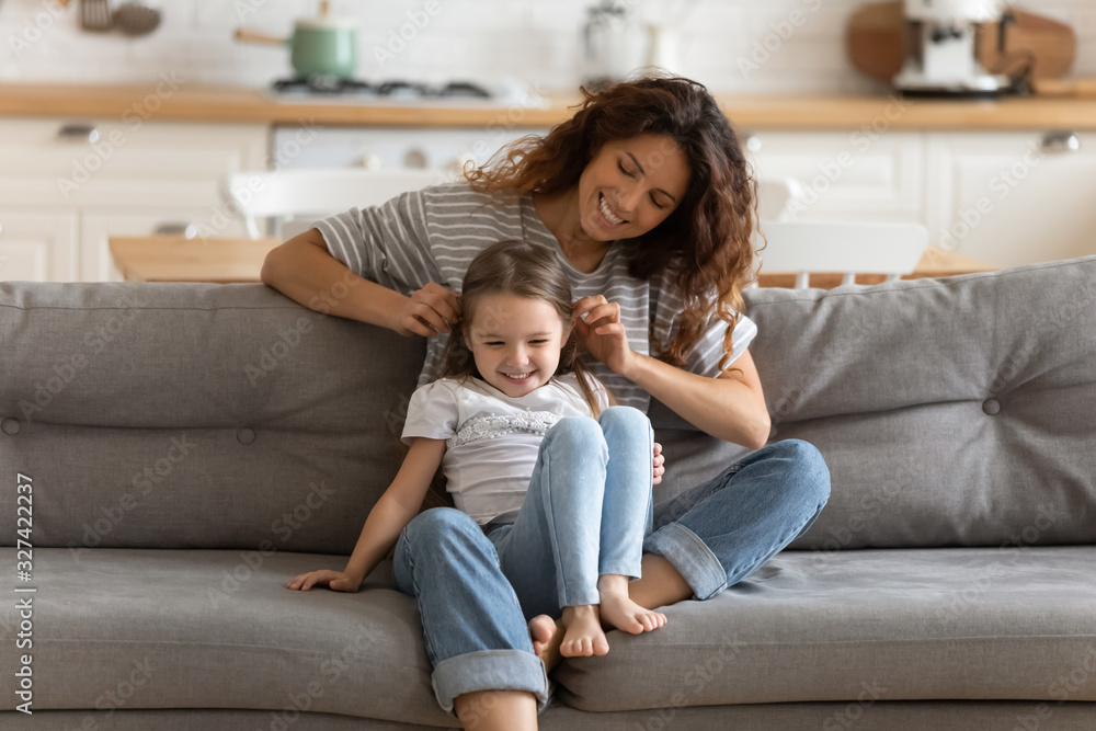 Happy mom play with little daughter in kitchen