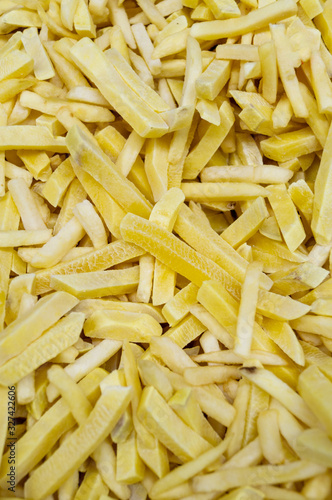 Frozen food semi-finished products - "French fries". Products are scattered in the refrigerator