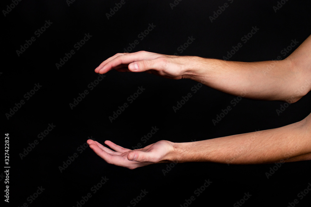 Hands on a black background show various action