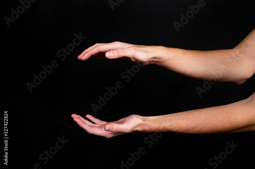 Hands on a black background show various action