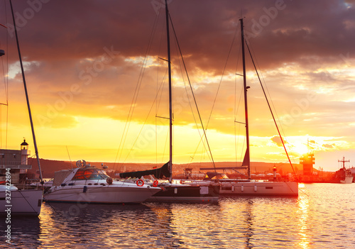 Yacht port and beautiful sunset over Varna, Bulgaria. Sailboat harbor, many beautiful moored sail yachts in the sea © ValentinValkov