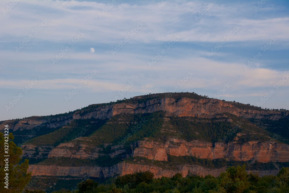 Fototapeta premium The big mountain with the moon one summer day