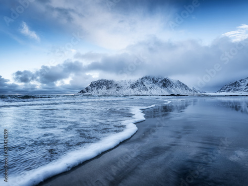 Skagsanden beach  Lofoten islands  Norway. Mountains  beach and wave. Winter landscape near the ocean. Norway - travel