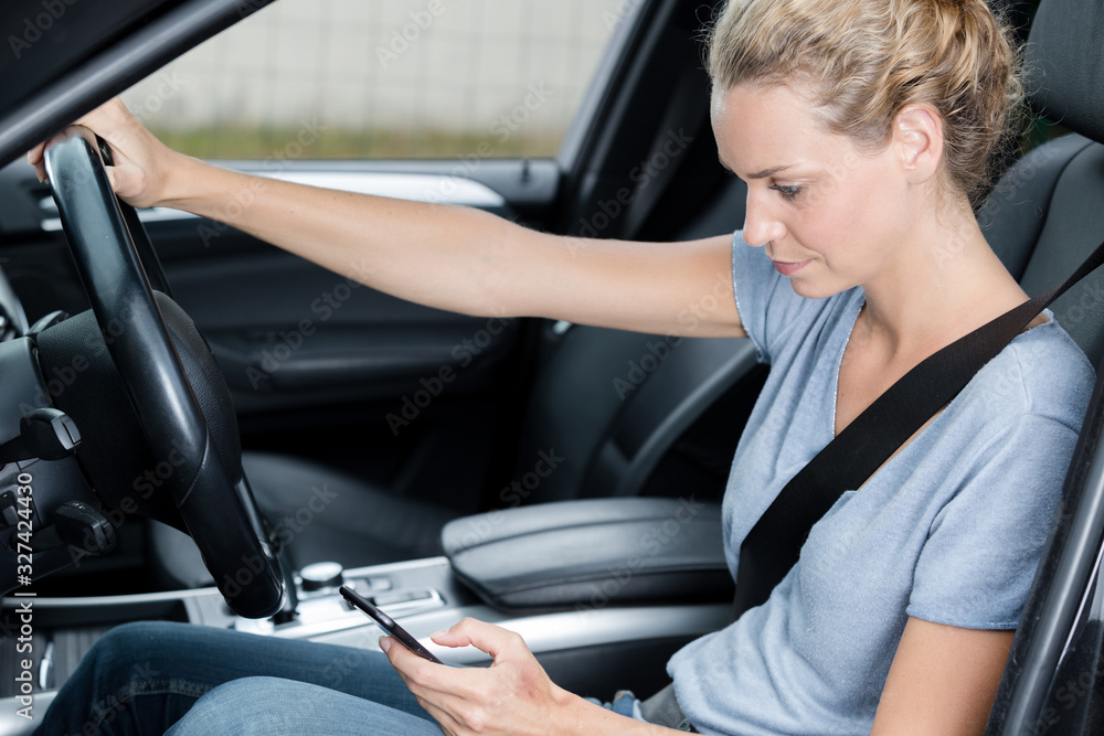 woman driver use her cell phone driving car