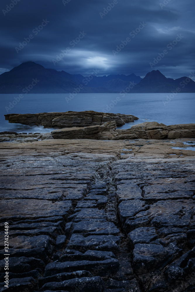 View on Cuillin Hills during late sunset/night from a small village Elgol, located in Isle of Skye, Scotland, UK