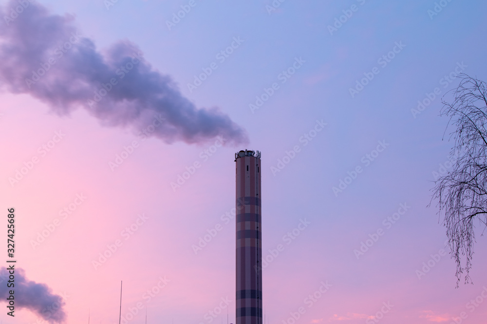 chimney of an incineration plant, dawn windy morning chimney of an incineration plant, dawn windy morning