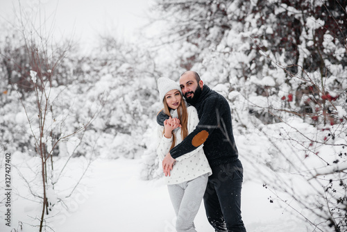 Couple playing with snow in the forest