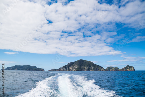 View on the poor knights rocks from a sailing motorboat during a diving trip photo