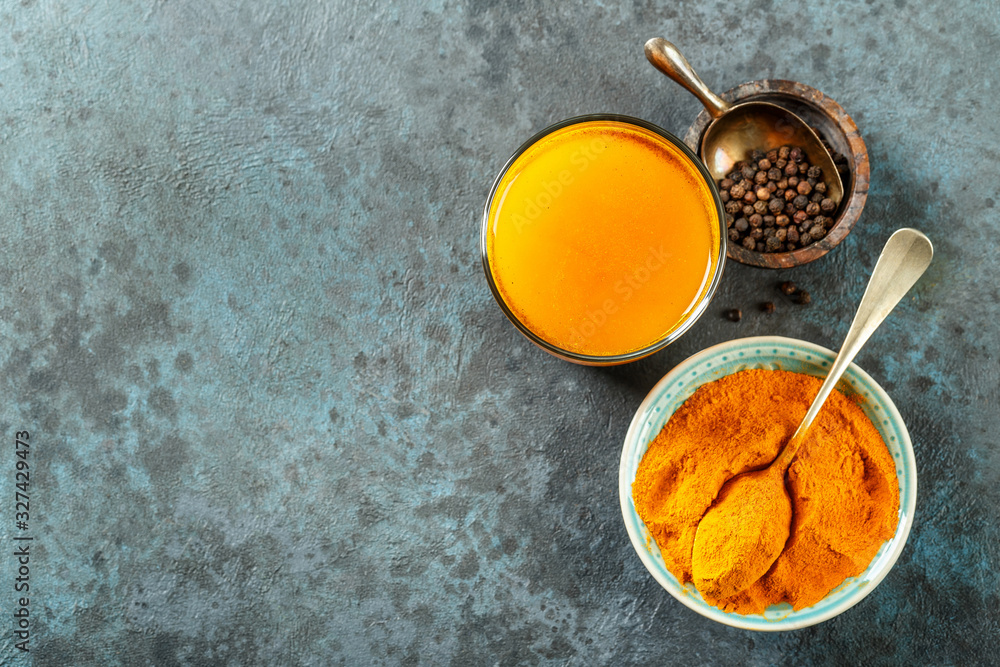 Fototapeta premium Turmeric with water and black pepper. Healthy eating. Top view, space for a text