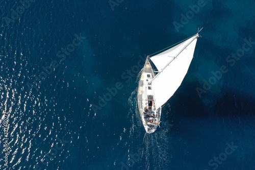 Aerial drone photo of beautiful sail boat cruising in deep blue open ocean sea