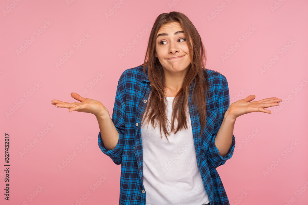 Don't know answer! Portrait of funny confused girl in checkered shirt shrugging shoulders with clueless embarrassed expression, having doubts, not sure. indoor studio shot isolated on pink background Don't know answer! Portrait of funny confused girl in checkered shirt shrugging shoulders with clueless embarrassed expression, having doubts, not sure. indoor studio shot isolated on pink background