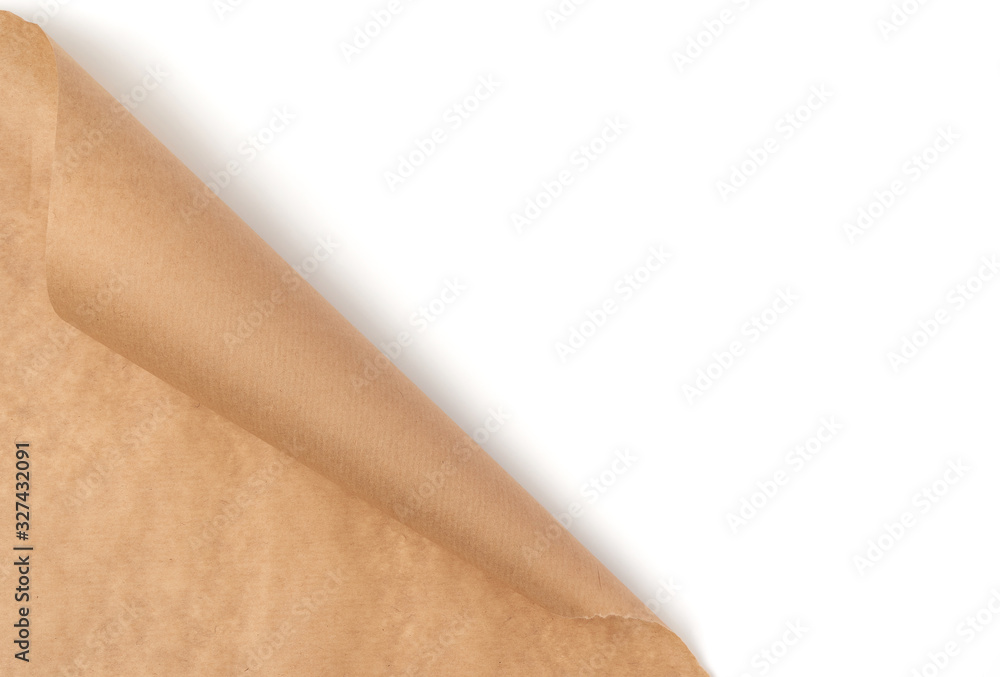 Obraz premium curved edge of a brown parchment paper sheet is isolated on a white background