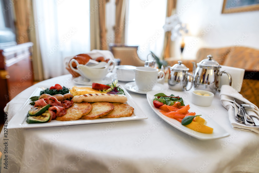 Luxurious Room Service. Close up of breakfast in luxury hotel room delivered by waiter. Hospitality and vacation concept - obrazy, fototapety, plakaty 