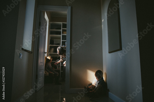 Tablou pe pânză Mom abuses and punish her daughter and a little boy sitting in a corner