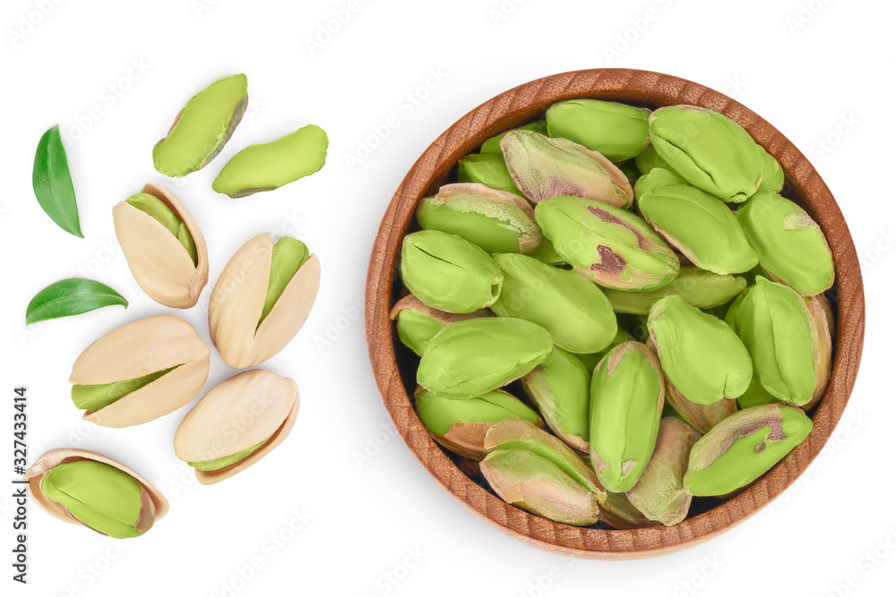 peeled pistachio in wooden bowl isolated on white background with clipping path and full depth of field. Top view. Flat lay peeled pistachio in wooden bowl isolated on white background with clipping path and full depth of field. Top view. Flat lay