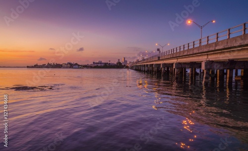 calm bridge bridge sunset orange blue sky night sun sky sunrise sea landscape road cloud river city buildings ocean beach nature illuminated dusk florida early morning port