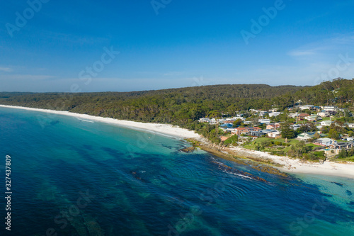 Aerial view of Hyams Beach, known for its vibrant white sand, at Jervis Bay on the New South Wales South Coast, Australia, known for its vibrant white sand looking over residential area on a sunny day © Steve