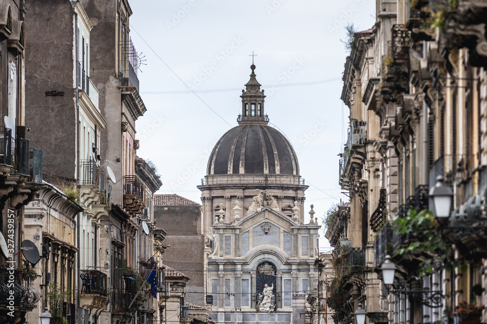 Fototapeta premium View from Giuseppe Garibaldi Street on St Agatha Cathedral, main religious landmark of Catania city on Sicily, autonomous region of Italy