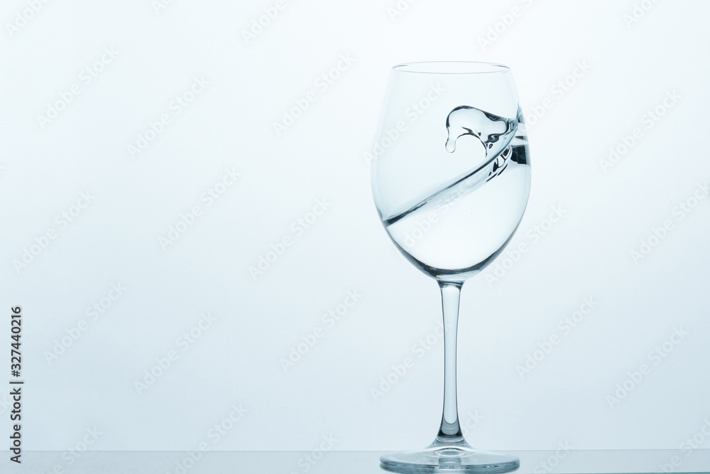 frozen movement of water in a glass on a blue-white background frozen movement of water in a glass on a blue-white background