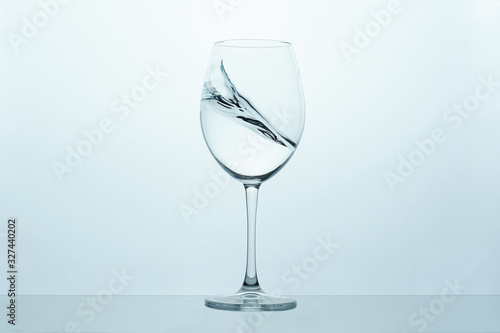 frozen movement of water in a glass on a blue-white background