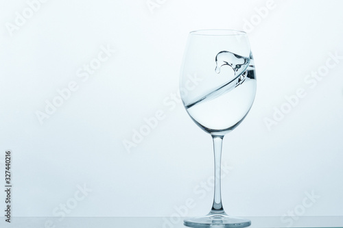 frozen movement of water in a glass on a blue-white background