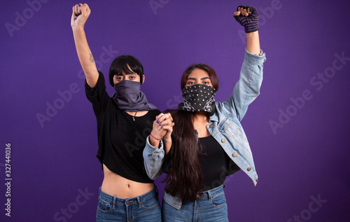 Covered face Latin girls protesting against gender injustice