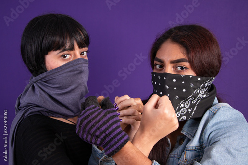 Covered face Latin girls protesting against gender injustice