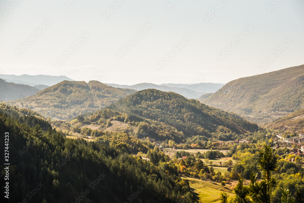 Obraz premium View over the beautiful lush landscape of Mokra Gora near the Zlatibor mountain in central Serbia during autumn taken from the resting spot of Sargan eight train station and tourist attraction