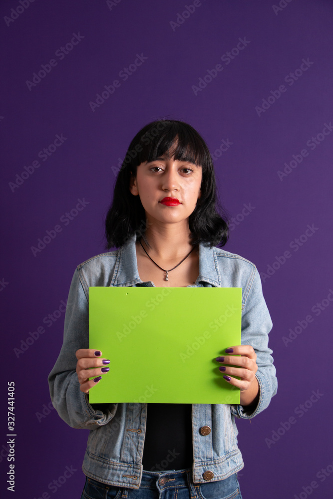 Young ethnic girl presenting an empty green screen board Young ethnic girl presenting an empty green screen board