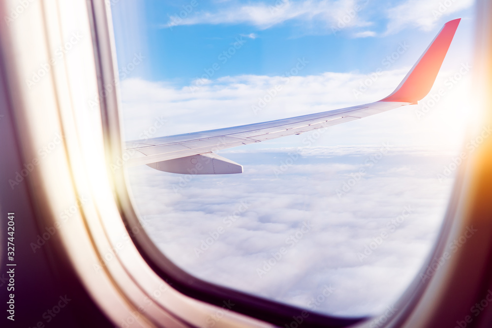 Black background with copy space with look of window frame of airplane flight see view of sunset clouds, airplane wing, ice mountains for luxury trip tourism travel transportation concept Black background with copy space with look of window frame of airplane flight see view of sunset clouds, airplane wing, ice mountains for luxury trip tourism travel transportation concept
