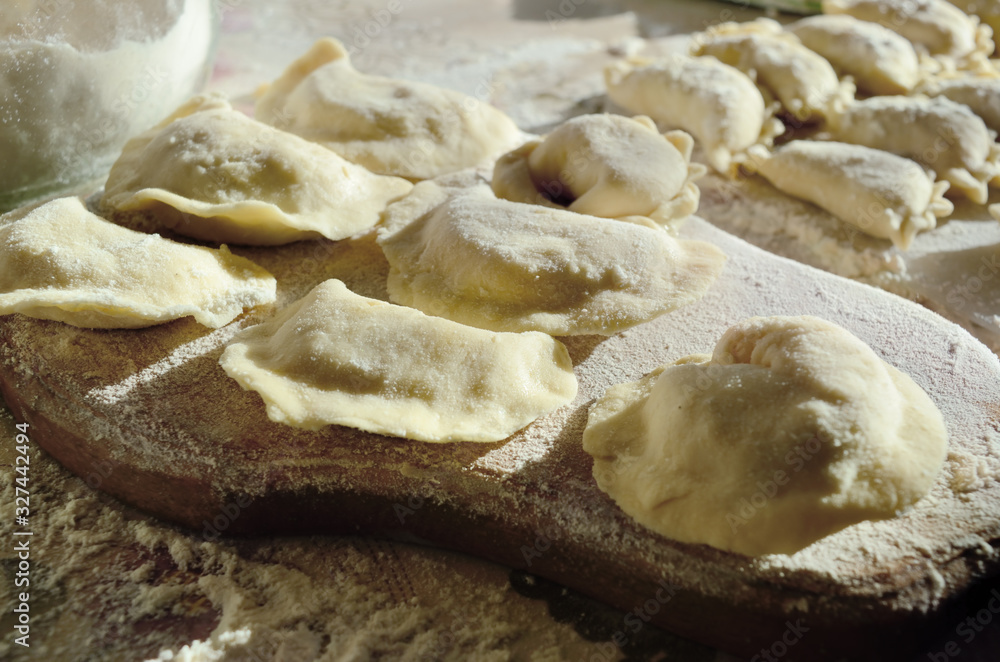 Dumplings, ravioli with cheese are on the kitchen table Dumplings, ravioli with cheese are on the kitchen table