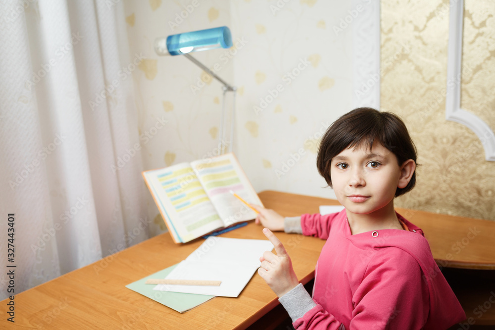 Smiling Asian schoolgirl doing homework. Smiling Asian schoolgirl doing homework.