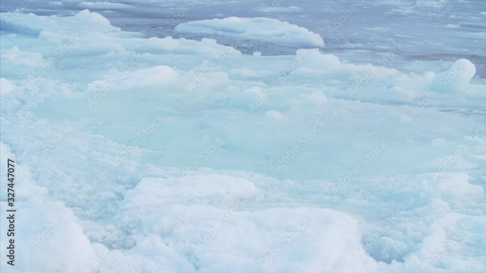 Beautiful sea waves are splashing with foam at big ice floes Beautiful sea waves are splashing with foam at big ice floes