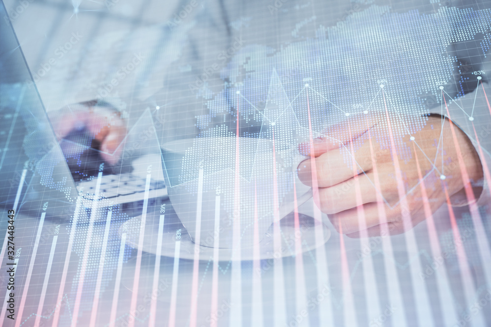 Double exposure of graph with man typing on computer in office on background. Concept of hard work. Double exposure of graph with man typing on computer in office on background. Concept of hard work.
