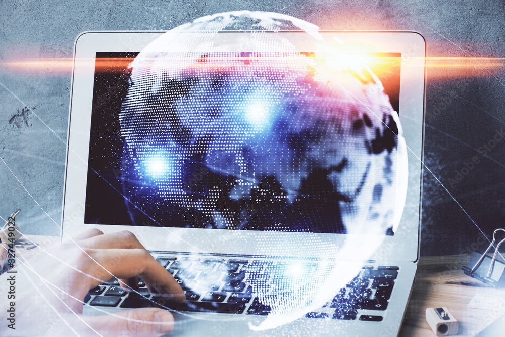 Double exposure of businessman working on laptop on background. International business hologram in front. Concept of success. Double exposure of businessman working on laptop on background. International business hologram in front. Concept of success.