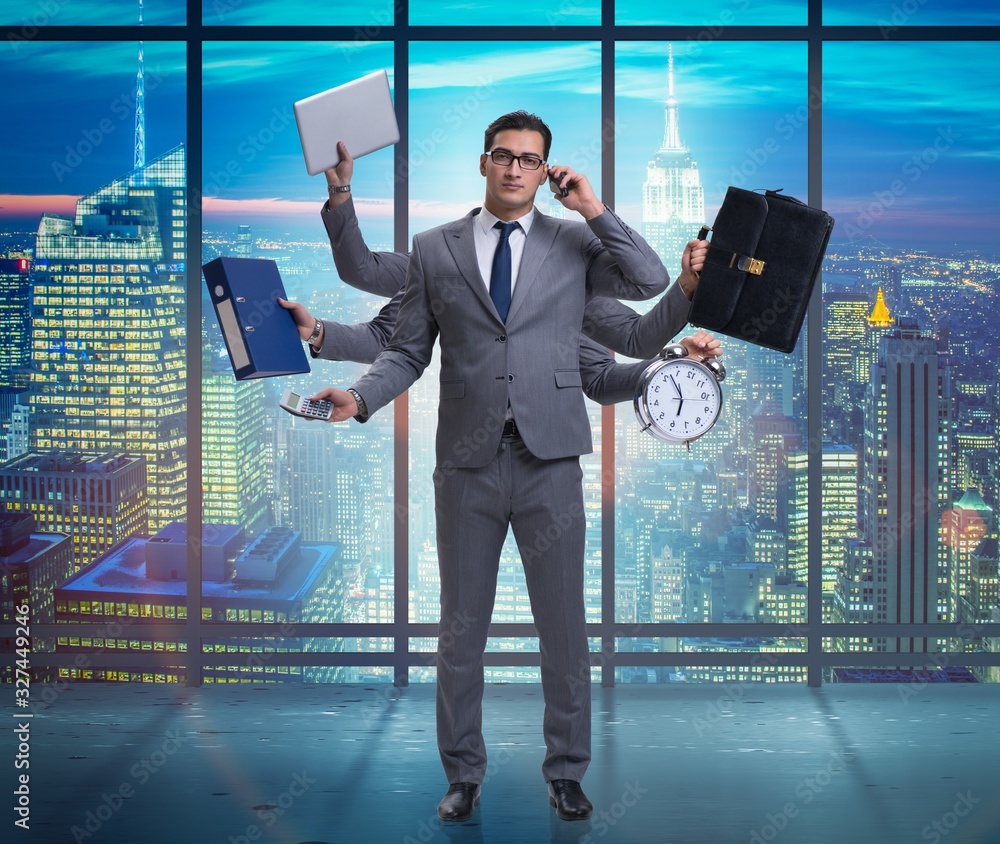 Fototapeta premium Young businessman in multitasking concept