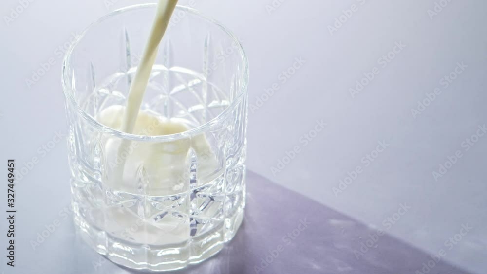 milk pouring in slow motion into glass milk pouring in slow motion into glass
