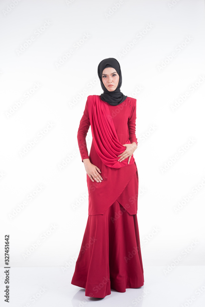 Beautiful female Asian model in various poses wearing a red Malaysian traditional wear isolated on white background. Beauty and fashion concept. Full length portrait