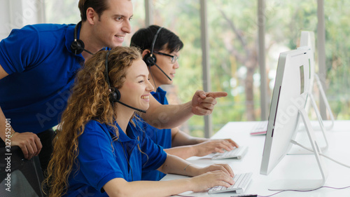 Photography customer service and call center agents are on training by call center superviso